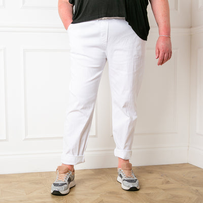 Plus size stretch trousers in white with pockets on either side. The bottom hem can be rolled up to any length 